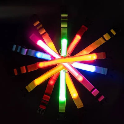 Colorful LED wristbands arranged in a circular pattern on a dark background