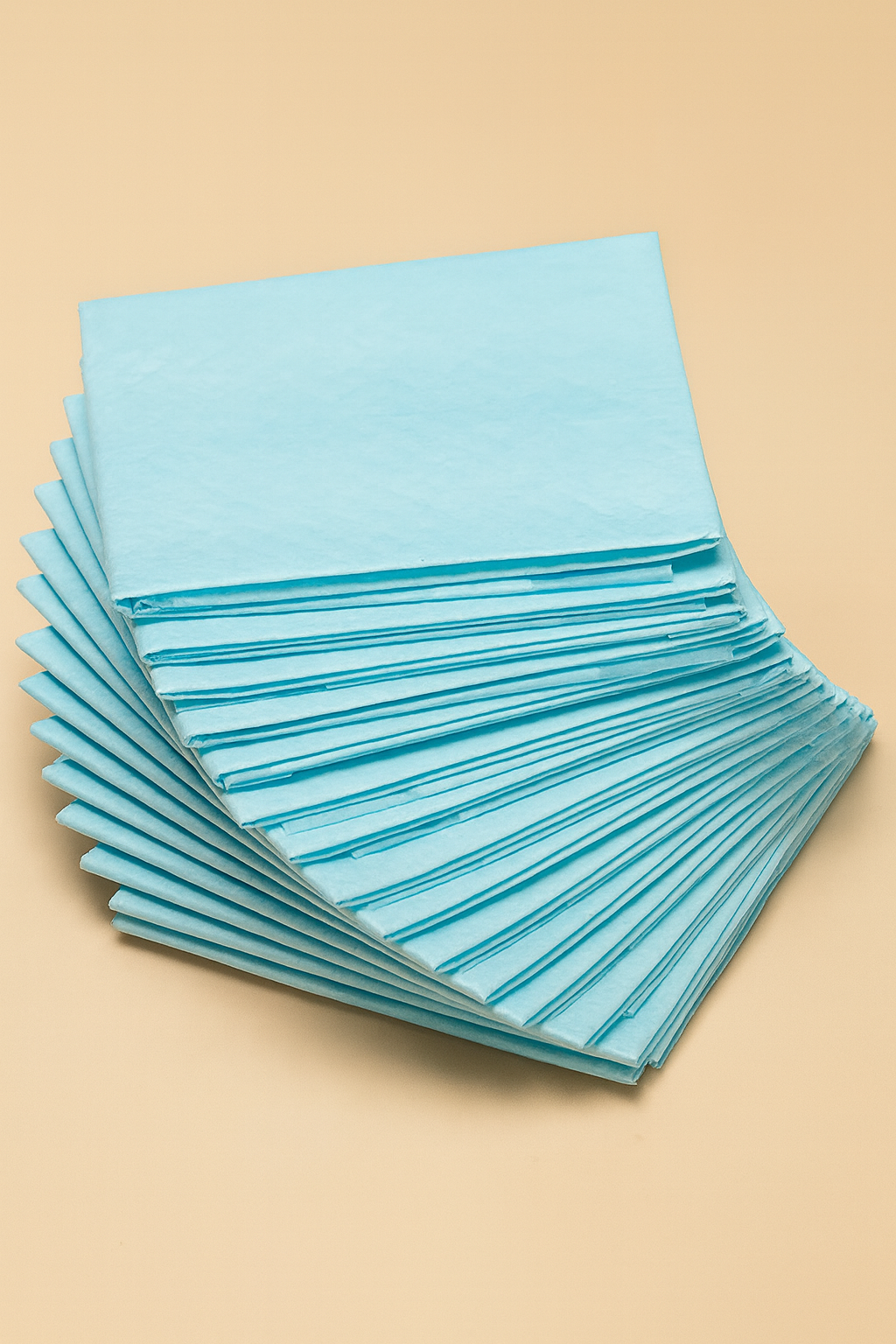 Stack of blue cleaning cloths on a beige background
