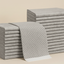 Stacks of gray folded towels on a beige background