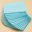 Stack of blue cleaning cloths on a beige background