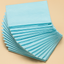 Stack of blue cleaning cloths on a beige background