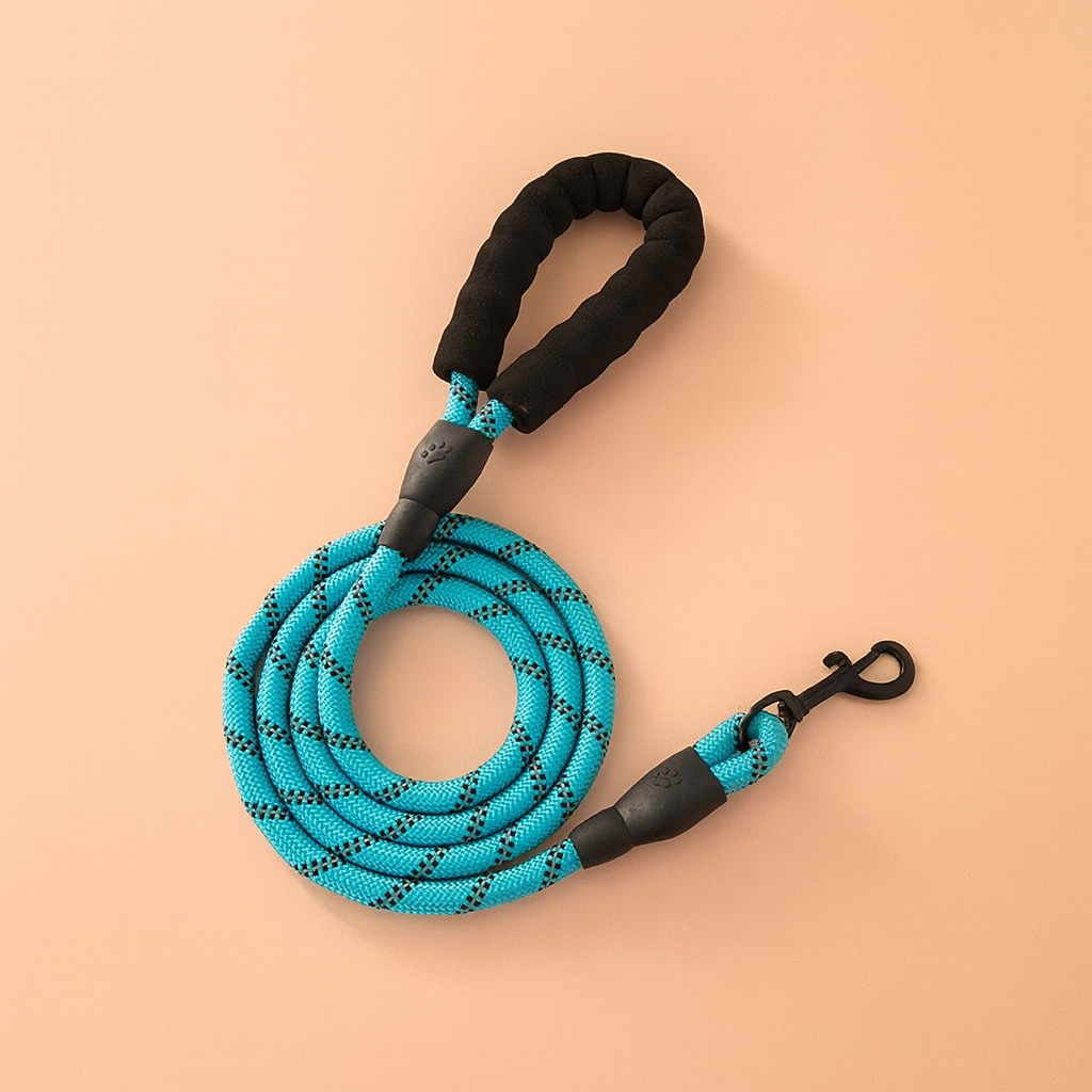 Blue dog leash with black handles on a beige background