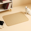 Beige pet mat on a beige floor with two cats, one black and white, the other white, in a minimalistic room.