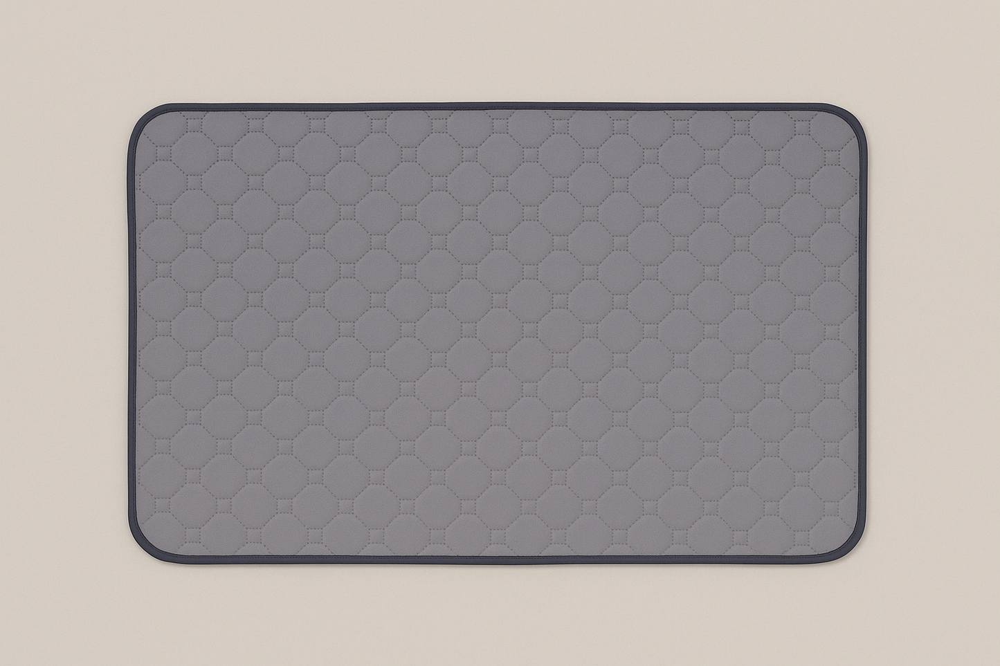Grey quilted mat on a beige background