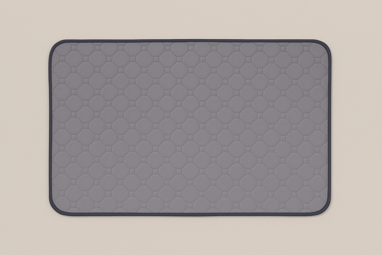 Grey quilted mat on a beige background